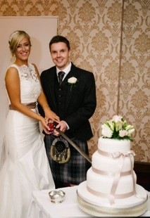 Karl and Lisa cutting the cake on their wedding day